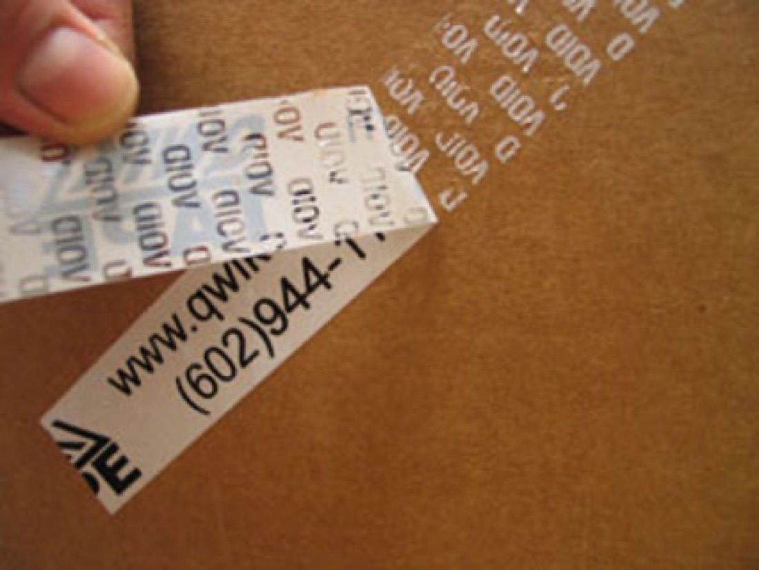 Tamper-evident security tape leaving a void pattern on a box